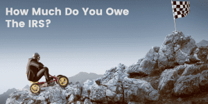 How much do you owe the IRS? A man riding a vehicle to the top of a mountain