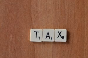 Scrabble tiles that spell out Tax