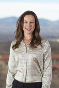 A professional bookkeeper standing by a mountain range