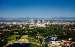 the denver skyline with a mountain backdrop