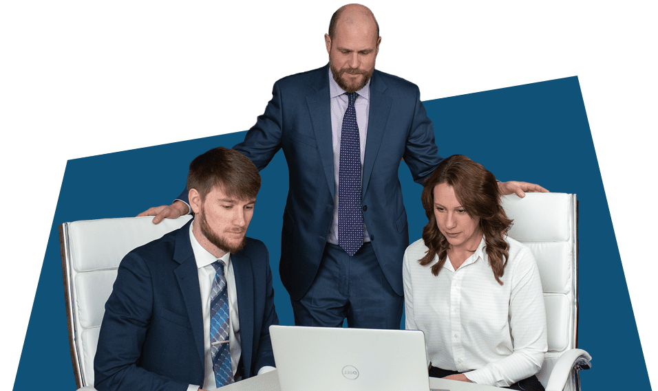 three professionals working at a table with a computer