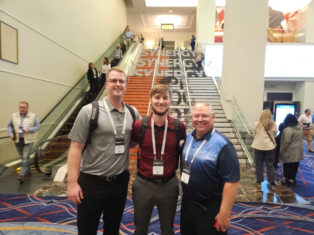 three tax professionals pose together at an accounting conference