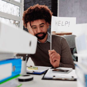 Man struggling with tax return; learning the three filing mistakes that cost you money